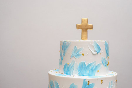 Spatula painted cake. White and blue baptism cake with golden cross topper.
