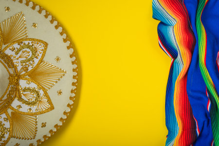 Mariachi hat and serape on yellow background. Mexican independence concept. Cinco de mayo background.の写真素材