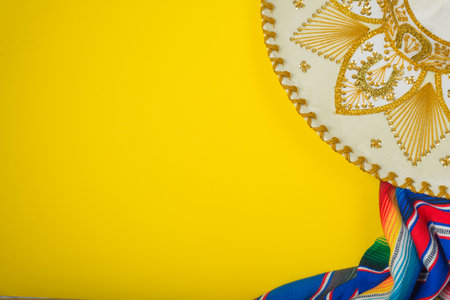 Mariachi hat and serape on yellow background. Mexican independence concept. Cinco de mayo background.の写真素材