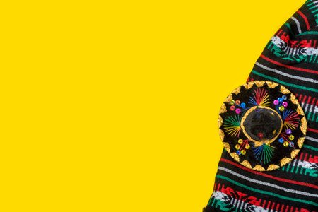 Mariachi hat and serape on yellow background. Mexican independence concept. Cinco de mayo background.の写真素材