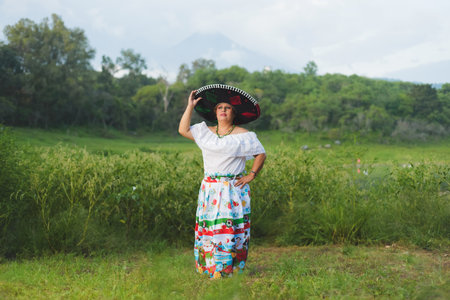 Woman with Mexican hat in rural scenery. Cinco de Mayo celebration in Mexico.の写真素材
