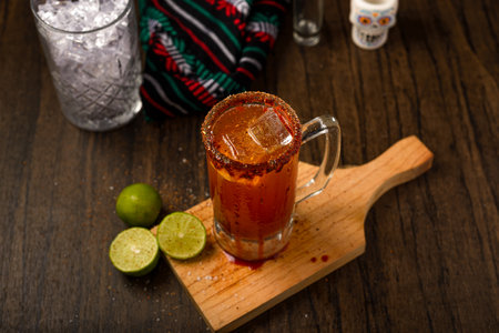 Michelada, typical mexican cocktail on a wooden table. Cocktail based on beer.の写真素材