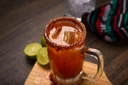 Michelada, typical mexican cocktail on a wooden table. Beer cocktail.の写真素材