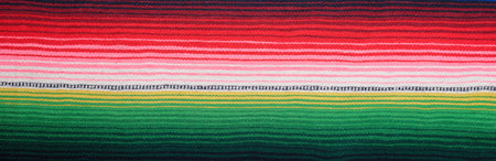 Cinco de Mayo background. Serape, colorful blanket with stripes. Banner.