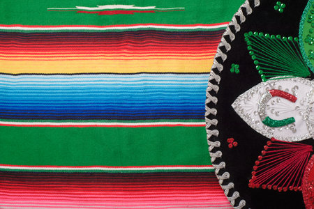 Mariachi hat on colorful serape. Mexican hat. Cinco de mayo background.