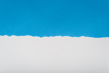 Blue torn paper on white paper background. Paper texture. Space for text.の写真素材