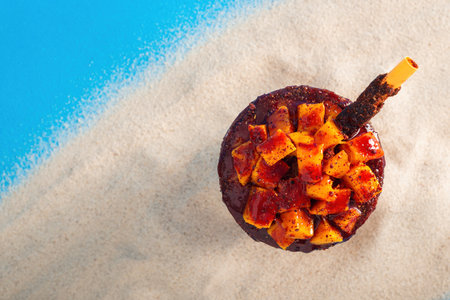 Mangonada, typical Mexican mango smoothie with chamoy sauce and lime juice. Top view.
