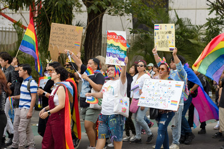 Colima, Colima. Mexico; june 15, 2024: People celebrating the LGBT+ Pride Parade waving the...