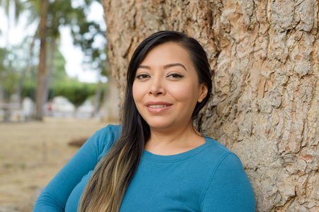 Woman in a public park with positive attitude, smiling.