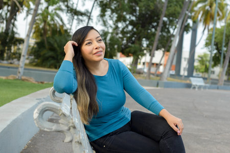 Woman in a public park with positive attitude, smiling.の写真素材