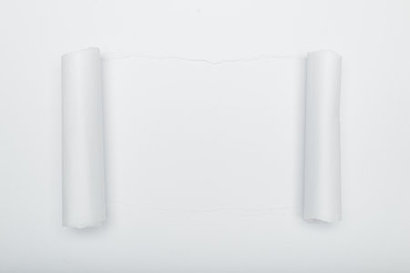 Torn white paper revealing a white background. Space for text.