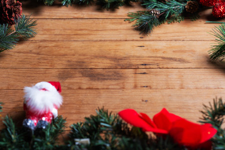 A rustic wooden background decorated with pine branches, red ornaments.の写真素材