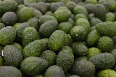 Group of hass avocados in a supermarket. Selective focus.