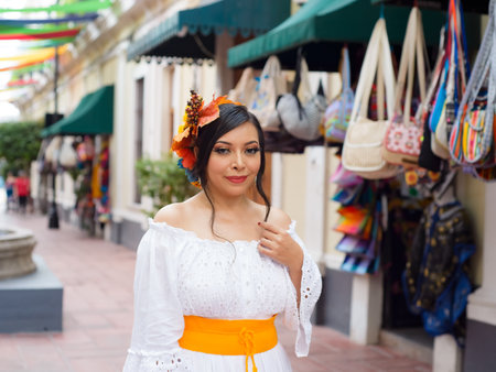 Street portrait of Mexican woman with craft stores in the background. Mexican Independence day celebration.の写真素材