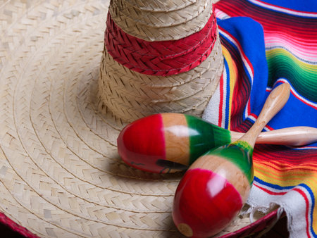 Maracas and serape on Mexican hat. Cinco de mayo background with copy space.の写真素材