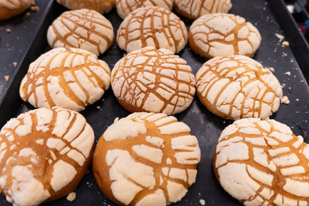 A tray of freshly baked shells on a bakery shelf.