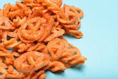 Various shapes of crispy seasoned flour duritos on a pastel blue background.の写真素材