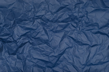 Texture of crumpled dark blue paper. Background.