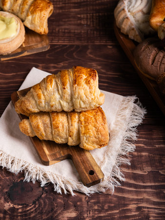 A tempting assortment of freshly baked pastries, featuring creamy custard-filled puff pastries...