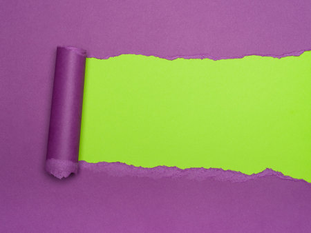 Torn Purple Paper Reveals Vibrant Lime Greenの写真素材