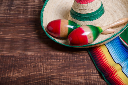 Maracas, serape and Mexican hat on wooden table. Mexican background.の写真素材