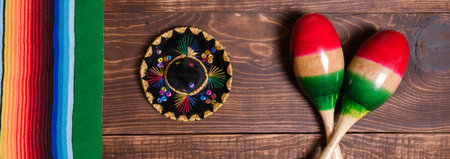 Maracas, serape and Mexican hat on wooden table. Mexican background. Bannerの写真素材