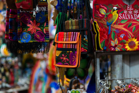 A close-up showcases colorful, handcrafted bags and embroidered textiles from El Salvador.の写真素材