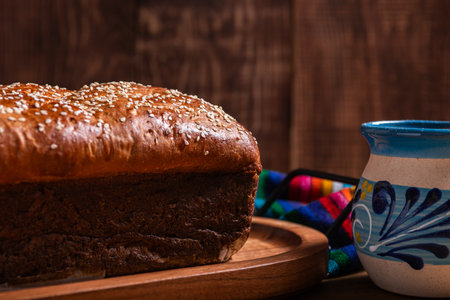 Salvadoran yolk bread, accompanied by a cup of hot chocolate.の写真素材