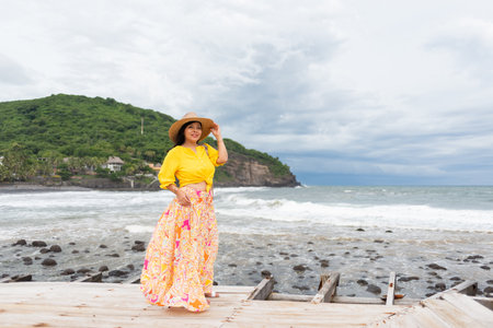 A woman is enjoying the landscape view on a cloudy day.の写真素材