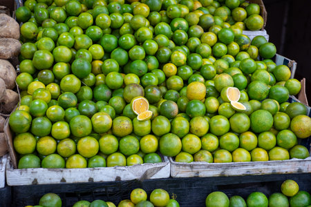 Bright Overhead Pile of Fresh Green Lime Fruit at Market Stall