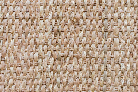 Detailed closeup of a woven basket surface, showing the natural texture and intricate pattern of the weaving.の写真素材