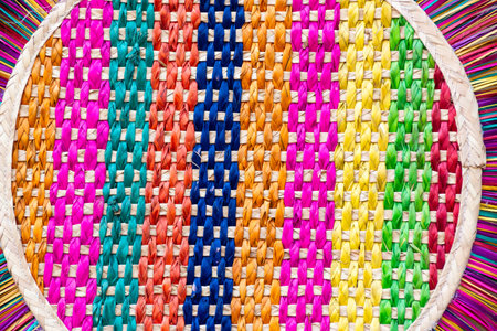 A handmade woven fan, featuring a vibrant array of colors and textures.の写真素材