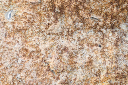 Close-up of brown rocky surface with rough texture, geology, natural background.の写真素材