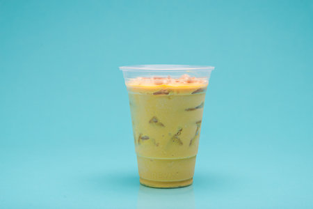 Handle mango pie in plastic cup on light blue background.の写真素材
