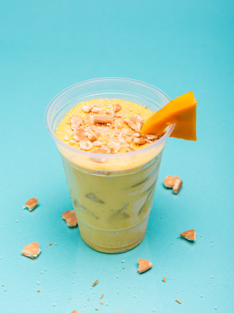 Handle charlotte in plastic cup on light blue background.の写真素材