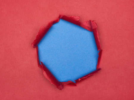 Torn Red Paper with Blue Background Texture and Copy Spaceの写真素材