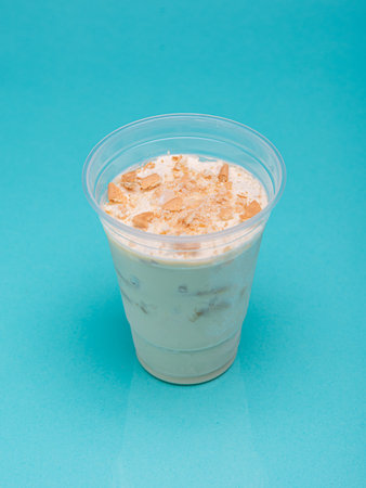 Lemon charlotte in a plastic cup on a light blue background.の写真素材