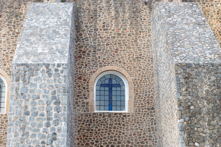 Antique Stone Wall Detail Featuring Arched Window with Cross Symbol. Architectureの写真素材