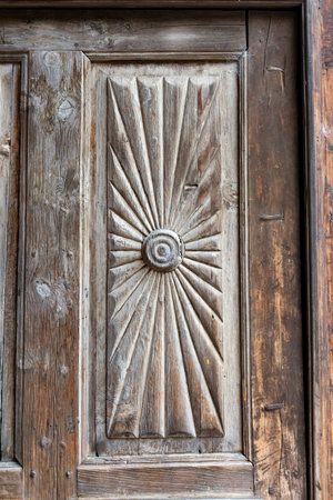 Wooden panel carved with detail of an aged rustic doorの写真素材