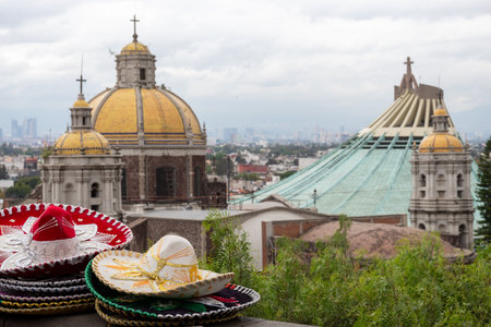 Colorful traditional Mariachi sombrero hats stacked on a ledge overlooking the Basilica of Guadalupe in Mexico Cityの写真素材