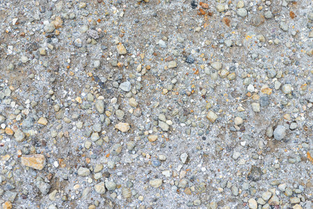 Close up of sandy ground interspersed with small pebblesの写真素材