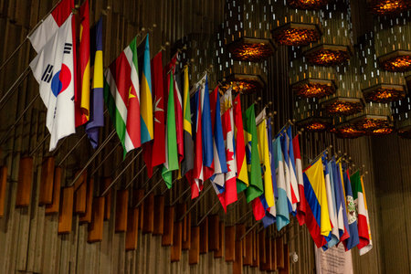 A collection of vibrant flags from around the world on display inside a basilica.の写真素材