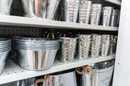 Shelf Full of Shiny Galvanized Metal Buckets and Pots