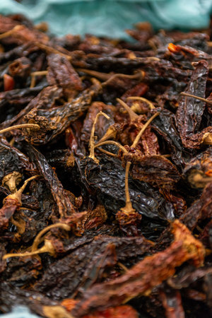 Close-Up Dry Chili Peppers Heap in a Container at Marketの写真素材