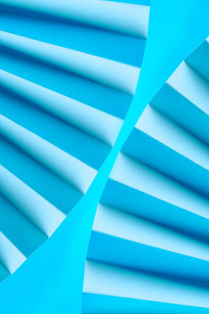 Folded blue paper creating a wave-like pattern.の写真素材