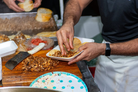 Delicious street-style Mexican tacos prepared at a market stall.の写真素材