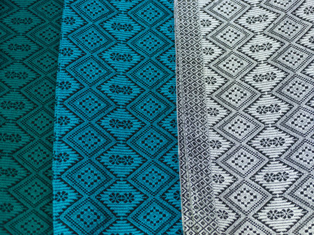 Traditional Detailed Textile Weave Pattern in Green, Blue, and Silver Fabrics
