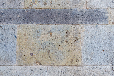 Ancient Textured Stone Block Wall Showing Wear and Weathering. Background