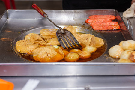 Fried Tortilla Chips and Sausage Cooking on Mexican Street Food Griddle
