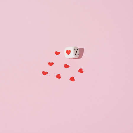 Dices with hearts on pink background. Love valentines concept.の写真素材